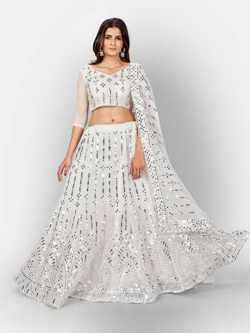 Garb This Partywear Heavy Designer Lehenga Choli And Dupatta In Fine Color Fabricated On Georgette Beautified With Heavy Attractive Thread,Mirror Embroidery Work.Buy Now. 