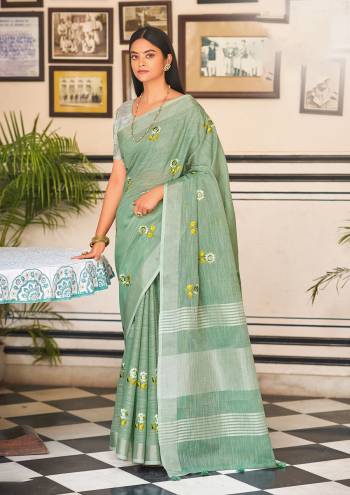 Garb This Traditional Saree Paired With Blouse.This Saree And Blouse Are Linen Based Fabric With Wevon Jari Designer With Embroidery Work. Buy This Pretty Saree Now.