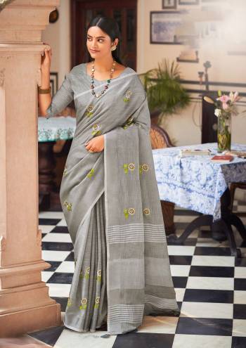 Garb This Traditional Saree Paired With Blouse.This Saree And Blouse Are Linen Based Fabric With Wevon Jari Designer With Embroidery Work. Buy This Pretty Saree Now.