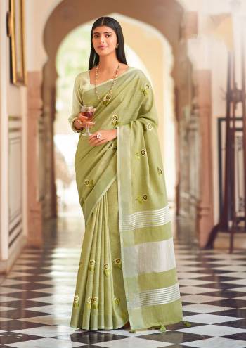 Garb This Traditional Saree Paired With Blouse.This Saree And Blouse Are Linen Based Fabric With Wevon Jari Designer With Embroidery Work. Buy This Pretty Saree Now.