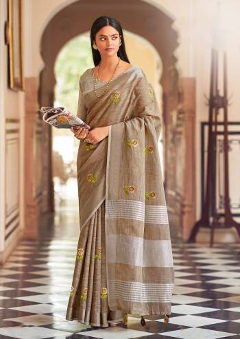 Garb This Traditional Saree Paired With Blouse.This Saree And Blouse Are Linen Based Fabric With Wevon Jari Designer With Embroidery Work. Buy This Pretty Saree Now.