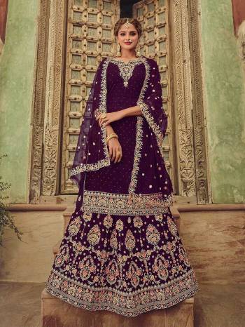 Garb This Designer Wedding Sharara Suit In Fine Color.Its Pretty Heavy Designer Embroidery With Diamond Work Top Is Georgette Based Paired With Georgette Bottom And Soft Net Fabricated Work Dupatta Which Gives An Attractive To The Suit.Buy Now.