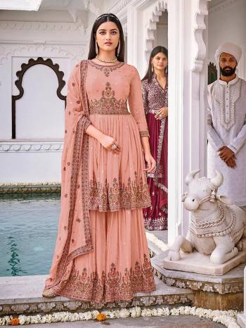 Attrective This Designer Sharara Suit In Fine Color.Its Pretty Heavy Designer Embroidery Work Top Is Georgette Based Paired With Georgette Bottom And Naznin Fabricated Dupatta Which Gives An Attractive To The Suit.