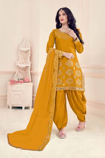 Enhance Your Personality Wearing This Designer Patiala Suit In Mustard Colored Top Paired With Matching Bottom And Dupatta.This Suit Is Bitalian Soft Silk Based Paired With Bitalian Soft Silkn Bottom And Net Dupatta. Buy Now