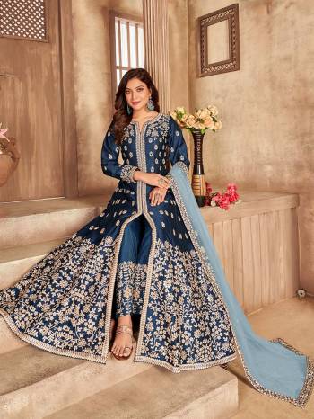 Get Ready For The Upcoming Festive And Wedding Season With This Designer Suit In Blue Color. This Suit Is Art Sllk Based Beautified With Heavy Real Mirror Embroidery Work All Over It. Buy Now