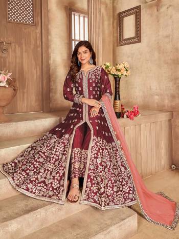 Get Ready For The Upcoming Festive And Wedding Season With This Designer Suit In Maroon Color. This Suit Is Art Sllk Based Beautified With Heavy Real Mirror Embroidery Work All Over It. Buy Now