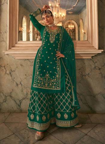 Here Is A Very Beautiful Designer Suit In Pretty Color Top is Fabricated On Georgette Pair With Readymade Georgette Bottom And Georgette Dupatta Beautified With Heavy Jari Embroidery Work