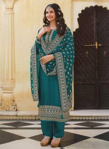 For A Designer Look,Grab These Beautiful Colored Suit Pair With Bottom And Dupatta.These Top is Fabricated On Dola Silk Pair With Santoon Bottom And Faux Georgette Dupatta.Its Beautified With Heavy Designer Embroidery And Swarovski Work.