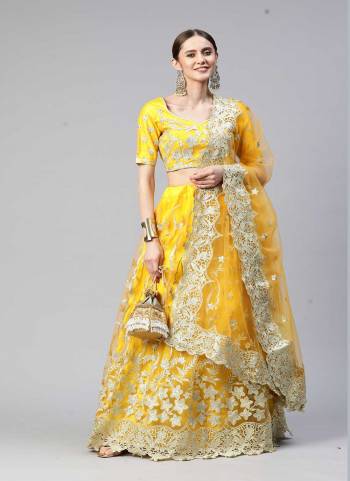 Heavy Designer Lehenga Choli In Yellow Color Fabricated On Net Beautified With Heavy Attractive Embroidery. 