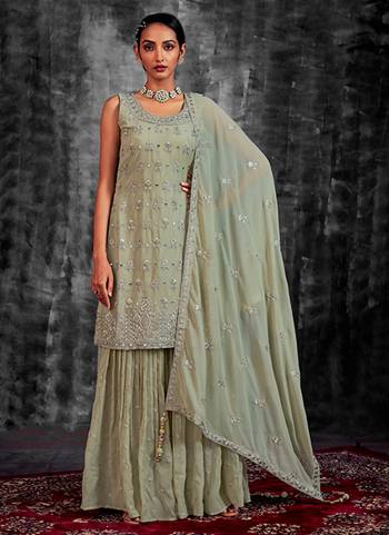 Garb These Readymade Sharara Suit in Fine Colored Pair With Bottom And Dupatta.These Top Are Georgette And Dupatta Are Fabricated On Georgette Pair With Georgette Bottom.Its Beautified With Heavy Designer Mirror,Thread,Jari Embroidery With Zarkan Work.