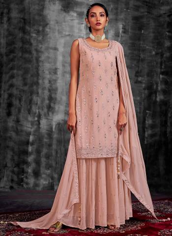 Garb These Readymade Sharara Suit in Fine Colored Pair With Bottom And Dupatta.These Top Are Georgette And Dupatta Are Fabricated On Georgette Pair With Georgette Bottom.Its Beautified With Heavy Designer Mirror,Thread,Jari Embroidery With Zarkan Work.