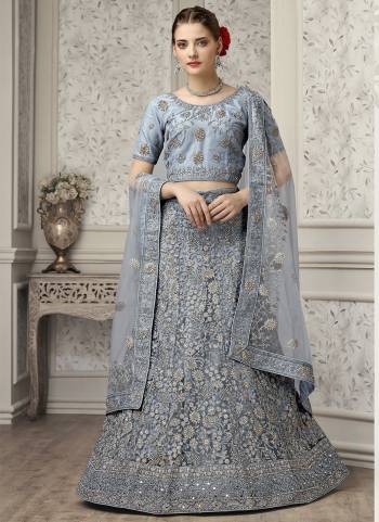 For A Fancy Heavy Designer Look,Grab These Lehenga Choli With Dupatta in Fine Colored.These Lehenga And Choli Are Net And Dupatta Are Fabricated On Soft Net Pair.Its Beautified With Designer Mirror,Jari Embroidery,Zarkan Work.