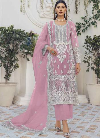 Pink colored pakistani suit is prettified with floral embroidered with moti work as shown which makes it appear classy. This top is made of organza silk fabric which is accompanied with santoon bottom, santoon lining and net work dupatta. Women can buy this suit to wear for their festive, parties, functions and event.