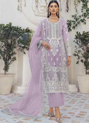 Purple colored pakistani suit is prettified with floral embroidered with moti work as shown which makes it appear classy. This top is made of organza silk fabric which is accompanied with santoon bottom, santoon lining and net work dupatta. Women can buy this suit to wear for their festive, parties, functions and event.