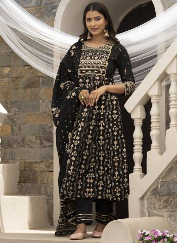 Kurta : Black Cotton Cambric Printed with Sequins work Anarkali Kurta, has a Round Neck , three-quarter regular sleeves with Gota patti lace, 
Bottom : Black Cotton Pant With lace Work 
Dupatta : Black Cotton Malmal Printed dupatta.