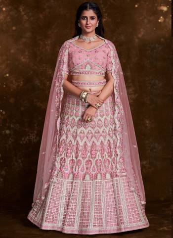 For A Designer Look,Grab These Lehenga Choli in Fine Colored.These Lehenga And Choli Are Fabricated On Net Pair With Soft Net Dupatta.Its Beautified With Heavy Designer Embroidery,Zarkan Work.