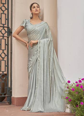 Garb These Designer Party Wear Saree in Fine Colored.These Saree Are Satin Chiffon And Blouse is Fabricated On Satin Chiffon Pair.Its Beautified Blooming Color With Swarovski Work Blouse,Border.