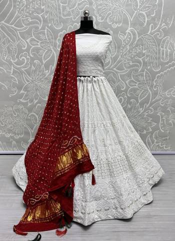 For A Fancy Designer Look,Grab These Lehenga Choli With Dupatta in Fine Colored.These Lehenga And Choli Are Georgette And Dupatta Are Fabricated On Gajji Silk Pair.Its Beautified With Designer Hand Knitting Bandhej Dupatta With Cotton Thread Lakhnavi Embroidery Work.