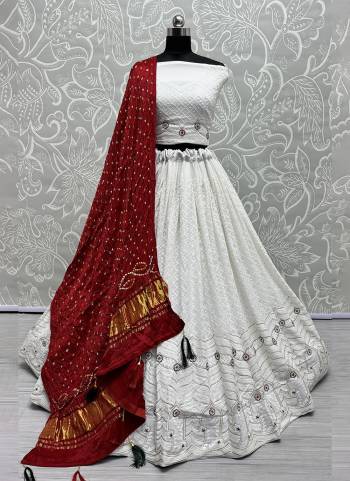 For A Fancy Designer Look,Grab These Lehenga Choli With Dupatta in Fine Colored.These Lehenga And Choli Are Georgette And Dupatta Are Fabricated On Gajji Silk Pair.Its Beautified With Designer Hand Knitting Bandhej Dupatta With Cotton Thread Lakhnavi Embroidery Work.