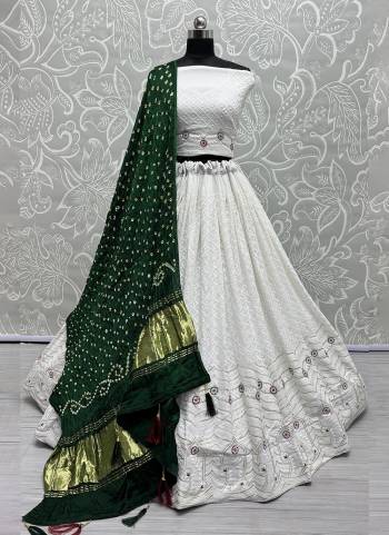 For A Fancy Designer Look,Grab These Lehenga Choli With Dupatta in Fine Colored.These Lehenga And Choli Are Georgette And Dupatta Are Fabricated On Gajji Silk Pair.Its Beautified With Designer Hand Knitting Bandhej Dupatta With Cotton Thread Lakhnavi Embroidery Work.