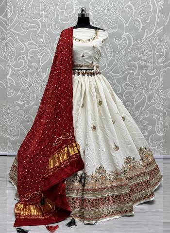 For A Fancy Designer Look,Grab These Lehenga Choli With Dupatta in Fine Colored.These Lehenga And Choli Are Gadhwal Silk And Dupatta Are Fabricated On Gajji Silk Pair.Its Beautified With Designer Hand Knitting Bandhej Dupatta With Cotton Thread Lakhnavi Embroidery Work.