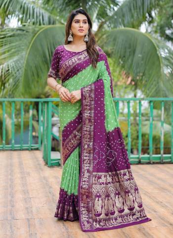 Garb These Festive Wear Saree in Fine Colored.These Saree And Blouse is Fabricated On Dola Silk.Its Beautified With Wevon Border Pallu Designer With Bandhj Handmade Printed.