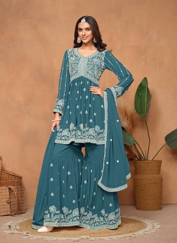 Garb These Party Wear Sharara Suit in Fine Colored Pair With Bottom And Dupatta.These Top And Dupatta Are Fabricated On Faux Georgette Pair With Faux Georgette Bottom.Its Beautified With Santoon Inner.Its Beautified With Designer Heavy Embroidery Work.