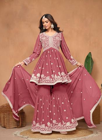 Garb These Party Wear Sharara Suit in Fine Colored Pair With Bottom And Dupatta.These Top And Dupatta Are Fabricated On Faux Georgette Pair With Faux Georgette Bottom.Its Beautified With Santoon Inner.Its Beautified With Designer Heavy Embroidery Work.