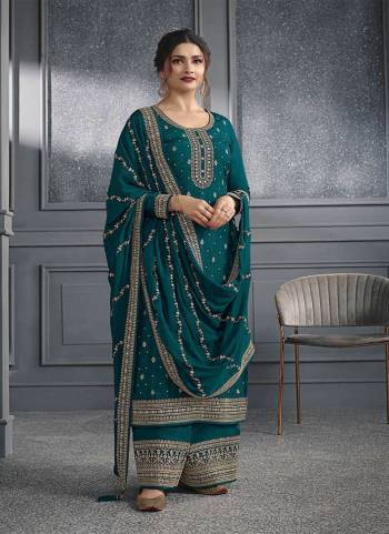 Teal Green colored Salwar suit is prettified with Embroidery work , Sequence Work and Diamond Work as shown which makes it appear classy. This top is made of Dola Silk fabric which is accompanied with Santoon bottom and Georgette dupatta. Women can buy this suit to wear for their parties and functions.