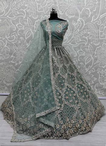 For A Fancy Designer Look,Grab These Lehenga Choli With Dupatta in Fine Colored.These Lehenga Are Net And Choli Are Net And Dupatta Are Fabricated On Soft Net Pair.Its Beautified With Designer Sequance,Thread,Dori,Badala Patti Embroidery With Zircon Diamond Work.