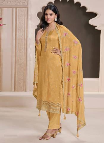 Yellow colored Salwar Suit is prettified with Embroidery work And Sequence Work as shown which makes it appear classy. This top is made of Silk fabric which is accompanied with Santoon Bottom,Santoon Inner and Georgette dupatta. Women can buy this suit to wear for their parties and functions.