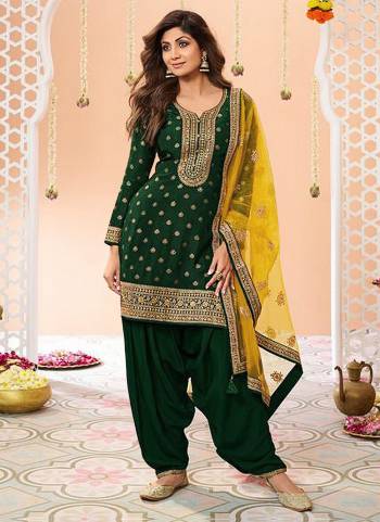 Garb These Designer Patiyala Suit in Fine Colored Pair With Bottom And Dupatta.These Top Are Jacquard Silk And Dupatta Are Fabricated On Net Pair With Santoon Bottom.Its Beautified With Santoon Inner.Its Beautified With Wevon Designer, Embroidery Work.