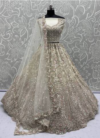 For A Fancy Designer Look,Grab These Lehenga Choli With Dupatta in Fine Colored.These Lehenga And Choli Are Net And Dupatta Are Fabricated On Soft Net Pair.Its Beautified With Fancy Designer Peacock Thread,Sequance,Dori Embroidery With Zarkan Diamond Work. 