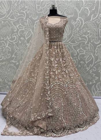 For A Fancy Designer Look,Grab These Lehenga Choli With Dupatta in Fine Colored.These Lehenga And Choli Are Net And Dupatta Are Fabricated On Soft Net Pair.Its Beautified With Fancy Designer Peacock Thread,Sequance,Dori Embroidery With Zarkan Diamond Work. 
