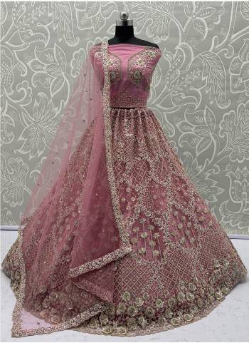 For A Fancy Designer Look,Grab These Lehenga Choli With Dupatta in Fine Colored.These Lehenga And Choli Are Net And Dupatta Are Fabricated On Soft Net Pair.Its Beautified With Designer Badala Patti,Sequance,Dori,Jari Embroidery With Zarkan Diamond Work