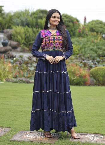Garb These Beautiful Navratri Wear Readymade Long Gown.These Gown is Fabricated On Rayon.Its Beautified With Designer Kutchi Gamthi Embroidery Work.