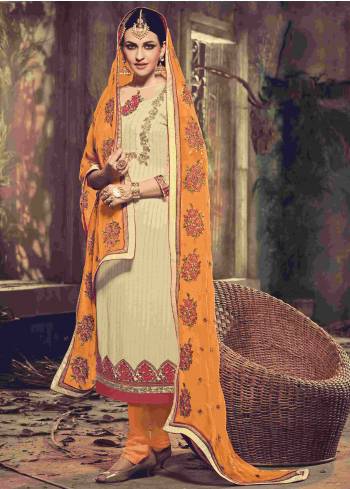 Look The Most Elegant Of All In Cream Colored Suit Paired With Musturd Colored Bottom And Dupatta. This Suit Is Pretified With Beautiful Floral Embroidery And Lace Borders. Grab This Unique Colored Suit Now.