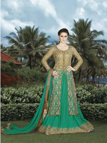 Add This Indo-Western Dress To Your Wardrobe. The Top Is In Beige Color Paired with Green Colored Lehenga And Duptta. The Fabric Used In This Dress Ensures Comfort For All Day Long.