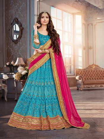 Look Beautiful In The Hues Of Blue With This Turquoise Blue Colored Lehenga Choli Paired With Rani Pink Colored Dupatta. This Lehenga Is Beautified With Heavy Embrooidery All Over. Pair This With Golden Colore Jhumkas And Flaunt Your Traditonal Look.