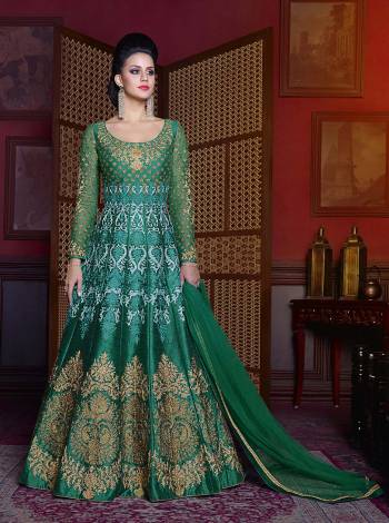 Color That Defines Harmony, Grab This Green Colored Floor Length Suit Paired With Green Colored Bottom And Dupatta. This Top Is Fabricated On Art Silk Beautified With Jari And Thread Work Paired With Santoon Bottom And Net Dupatta. Buy This Suit Now.