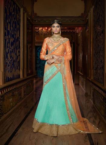 Get Some Unique Colors In Your Ethnic Wear With This Pretty Lehenga Choli. Its Light Orange Colored Choli Is Paired With Aqua Blue Colored Lehenga And Light Orange Colored Dupatta. It Is Beautified With Sophisticated Embroidery Over The Blouse And Dupatta. Buy This Lehenga Choli Now.