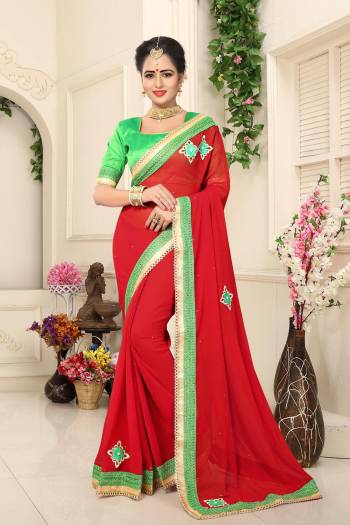 For A Proper Traditonal Look, Grab This Saree With Combination In Traditonal Colors. Grab This Saree In Red Color Paired With Contrasting Green Colored Blouse. This Saree Is Fabricated On Georgette Paired With Art Silk Fabricated Blouse. 