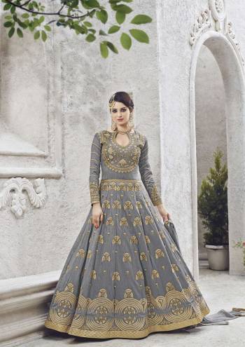 Embodying a perfect blend of traditional and contemporary elegance, this grey semi-stitched salwar suit is finished with a floral embroidered on the Yoke. Fashioned from cherry silk fabric, This attractive suit is the flavour of the season and will give you a classy look. Complement this set with heels.