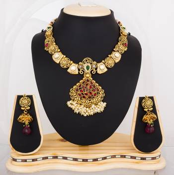 Here Is A Proper Traditonal Necklace Set In Golden Color Beautified With Multi Colored Stones. This Lovely Set Can Be Paired With Any Contrasting Colored Attire. Buy Now.