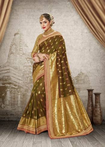 Here Is A New And Unqiue Colored Saree Which Will Give A Rich Look To Your Personality Like Never Before. This Saree Is In Olive Green Color Paired With Golden Colored Blouse. This Saree And Blouse Are Fabricated On Banarasi Art Silk Beautified With Weave And Embroidered Lace Border.