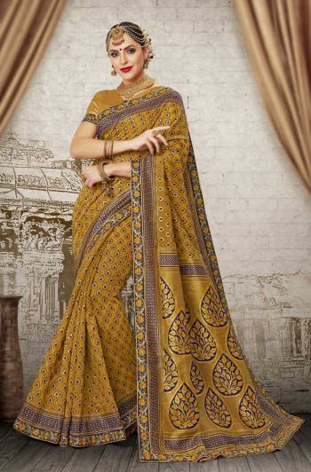 Earn Lots Of Compliments Wearing This Saree In Musturd Yellow Color Paired With Musturd Yellow Colored Blouse. This Saree And Blouse Are Fabricated On Banarasi Art Silk Beautified With Beautified With Weave And Lace Border. 