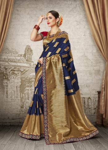 Grab This Designer Silk Saree In Navy Blue Color Paired With Contrasting Red Colored Blouse. This Saree And Blouse Are Fabricated On Banarasi Art Silk Beautified Elegant Weave And Lace Border. Buy This Saree Now.