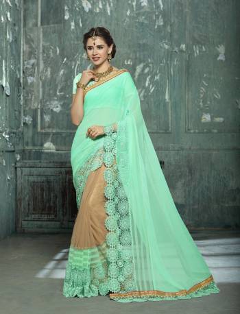 Here Is A Very Pretty Designer Saree In Sea Green And Beige Color Paired With Sea Green Colored Blouse. This Saree Is Fabricated On Chiffon And Net Paired With Art Silk Fabricated Blouse. Its Attractive Lace Border Will Earn You Lots of Compliments From Onlookers.