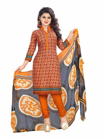 Add This New Color In Your Casuals To Your Wardrobe With This Rust Orange Colored Top Paired With Orange Colored Bottom And Grey Colored Dupatta. Its Top And Bottom Are  Fabricated On Cotton Paired With Chiffon Dupatta. This Suit Will Earn You Lots Of Compliments From Onlookers. Buy This Dress Material Now.