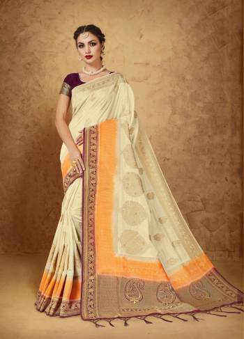 Flaunt Your Rich And Elegant Taste Wearing This Saree In Cream Color Paired With Contrasting Wine Colored Blouse. This Pretty Saree Is Fabricated On Banarasi Art Silk Paired With Banarasi Art Silk Blouse. This Saree Has Beautiful Elegant Weave All Over It Which Will Earn You Lots Of Compliments From Onlookers. 